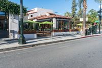 a picture of a corner that looks like the street with an umbrella stand in the middle