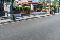 a picture of a corner that looks like the street with an umbrella stand in the middle