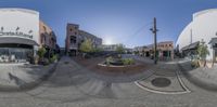 the view of a street from an intersection through a fisheye lens and the sun shining through