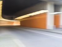 an abstract photo of a person riding down the street while a car is coming up and out