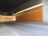 an abstract photo of a person riding down the street while a car is coming up and out