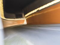 an abstract photo of a person riding down the street while a car is coming up and out