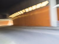 an abstract photo of a person riding down the street while a car is coming up and out