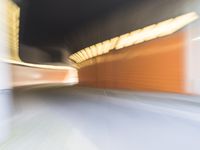 an abstract photo of a person riding down the street while a car is coming up and out