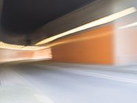 an abstract photo of a person riding down the street while a car is coming up and out