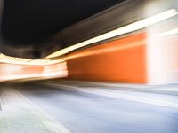 an abstract photo of a person riding down the street while a car is coming up and out