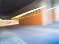 an abstract photo of a person riding down the street while a car is coming up and out