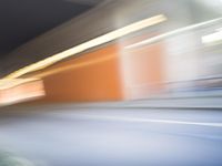 an abstract photo of a person riding down the street while a car is coming up and out