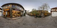 a street view of several shops in an urban setting with no one sitting or standing