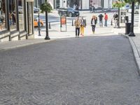 there are many pedestrians walking on the streets on this sunny day today in the city