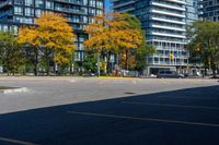 a bus stop sign in a parking lot near a tall building with trees and cars