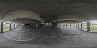 a 360 view of an empty parking garage with no one in sight of it looking down at the empty space