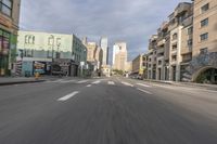 a view of an empty city street from the back seat of a car while driving in the city