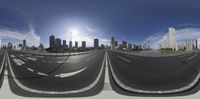 a road on the horizon of a city with skyscrapers in the background, and a lens of the road with the view