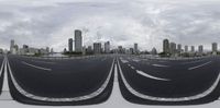 the city skyline is seen through the glass lens of a virtual reality set up in front of a large road