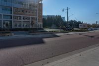 a street view with two buildings on either side of the road and a person walking in front of it