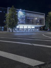 the intersection of a crosswalk and a traffic light in an urban city area at night