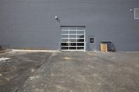 a garage door that has been opened to let a truck inside and parked outside it