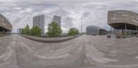 a full view of a modern architectural structure in a city area taken with fisheye lens