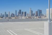 a parking lot with some buildings in the background and a blue sky in the foreground