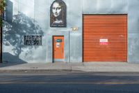 an image of a door, on the side of the building near the fire hydrant and in the foreground it is a mural of a woman with the sunliting