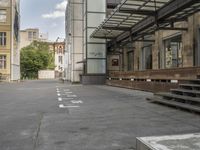 an empty building with signs on the street and people on bikes in traffic passing by