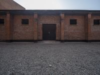 two brick buildings are shown in an empty space with no roof, and the building is not