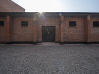 two brick buildings are shown in an empty space with no roof, and the building is not