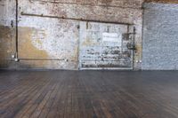 an old warehouse has a wooden floor and door in it, next to a brick wall and stairs