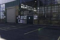 a lone white motorcyclist parked near the side of the street in an industrial area