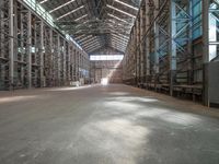 the empty warehouse with multiple steel racks is ready to be filled with other items for consumption