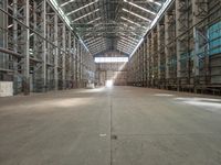 the empty warehouse with multiple steel racks is ready to be filled with other items for consumption