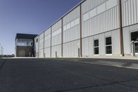 a large commercial building that is painted grey and has a sign for an airport next to it