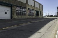 a sidewalk near a car wash station and a road with a red fire hydrant