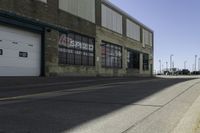 a sidewalk near a car wash station and a road with a red fire hydrant