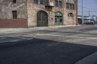 a stop sign sitting in the middle of an empty road near a building with a number four on it