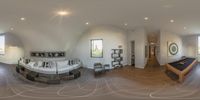 a fisheye image of a large white room and pool table in the middle of the room