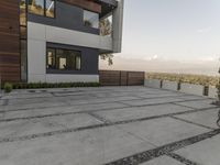 the exterior and landscape of a modern house in los angeles, california with stone and wood