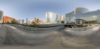 an abstract picture of city with tall buildings from above and below as the skateboarder rides down an almost - paved ramp