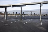 an empty car park with parked cars on either side and empty space for vehicles to use