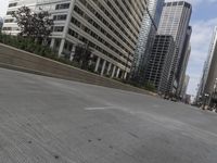 a city street with cars and tall buildings in the background, with a skateboarder in midair