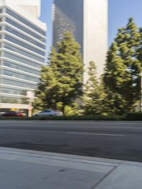 a street scene with blurry cars on the street and a building in the background