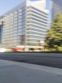 a street scene with blurry cars on the street and a building in the background