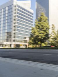 a street scene with blurry cars on the street and a building in the background