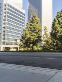 a street scene with blurry cars on the street and a building in the background