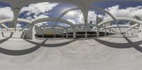 this is an image of a panorama lens taken at a city street, with the building and cars in the foreground