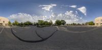 the circular image was taken of a circular driveway with buildings and trees in front of it