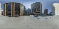 the image shows a building and some skateboarders on a board ramp in the background