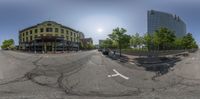 a full view of a street with people walking and trees outside, in a fish eye picture