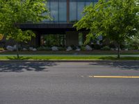 a building with a logo painted on the side near a street that has a sidewalk next to it